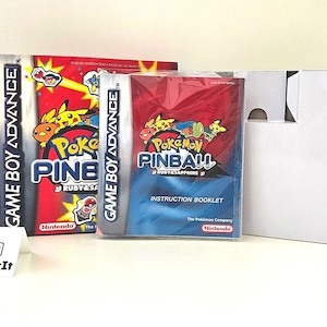May include: A Game Boy Advance game cartridge for Pokemon Pinball: Ruby & Sapphire. The game is in its original packaging, which includes a red and blue instruction booklet. The game is in a clear plastic case.