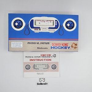 May include: A blue box featuring a Nintendo Micro vs. System Donkey Kong Hockey game. The box has a white and blue design with two circular controllers. An instruction manual is below the box, with the GoBoxIt logo at the bottom.