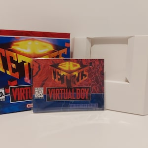 May include: A red, white, and blue box with the words "3D Tetris Virtual Boy" on it. The box is open and the instruction booklet is visible. The booklet is a blue and red design with the words "3D Tetris Virtual Boy" on it.