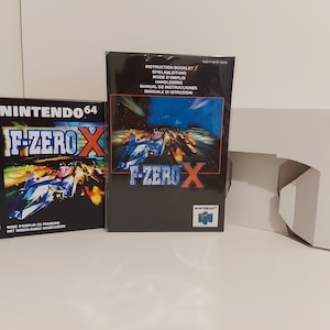 May include: A Nintendo 64 game cartridge and instruction booklet for the game F-Zero X. The box art features a blue and white spaceship racing on a futuristic track.