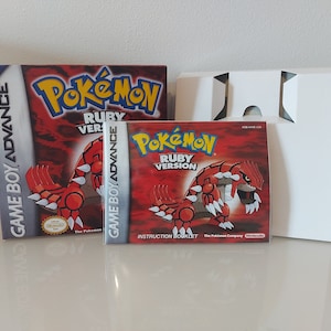May include: A red and white Game Boy Advance game cartridge and instruction booklet for Pokemon Ruby Version. The box art features a red, spiky Pokemon with white claws.