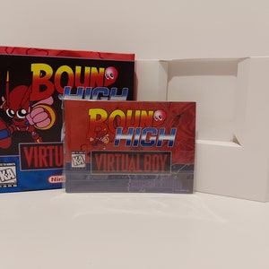 May include: A red and blue Virtual Boy game cartridge case with the title "Bound High" and a cartoon robot character. The case is in a clear plastic sleeve and is sitting on a white surface.