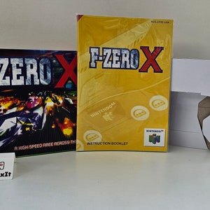 May include: F-Zero X game box and instruction booklet for the Nintendo 64. The box art features a futuristic racing scene with the game's title in bold letters. The instruction booklet is yellow with the game's title.