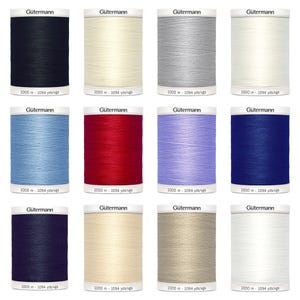 May include: Twelve spools of Gütermann thread in various colours, including black, white, grey, red, blue, light blue, beige, and cream. Each spool contains 1000 metres or 1094 yards of thread.