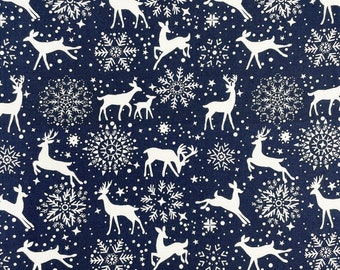 May include: A navy blue fabric with a white repeating pattern of snowflakes and stylized deer. The pattern is a classic Christmas design.