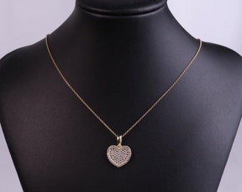 May include: A gold chain necklace with a heart-shaped pendant encrusted with small clear stones.