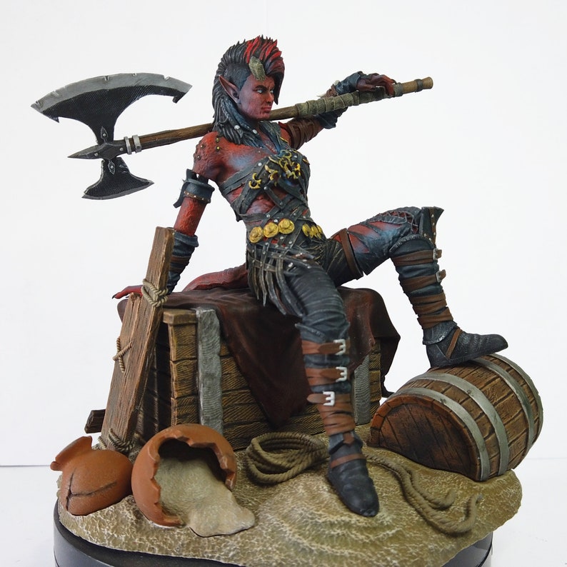 May include: A detailed figurine of a female warrior with red skin, horns, and a mohawk hairstyle. She is posed with an axe over her shoulder, wearing armor and seated on a wooden crate. A barrel and broken pottery are also present.