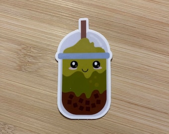 May include: A green and brown cartoon bubble tea with a smiling face and a straw. The bubble tea has a white lid and a blue stripe around the middle.