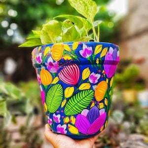 Beautiful hand painted colorful jungle flowers succulent clay pot planter for indoors and outdoors.