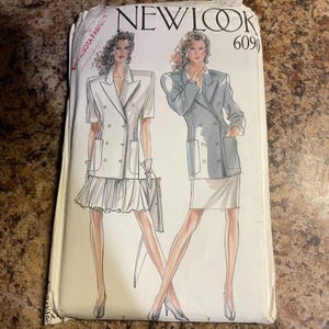May include: A vintage sewing pattern packet with illustrations of women's suits. The packet has the "NEW LOOK" logo and the number "6090" printed on it. The suits are double-breasted blazers with skirts.