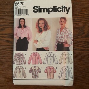 May include: Simplicity sewing pattern number 8620, size H (5-10), for a blouse with different collar and sleeve variations. The pattern shows a model wearing a pink blouse with a ruffled collar and a white blouse with a Peter Pan collar.