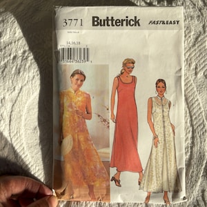May include: A Butterick sewing pattern envelope featuring illustrations of three different long dresses. The envelope is white with the number 3771 and the words "Butterick FAST & EASY" printed on it. The size is 14, 16, 18.