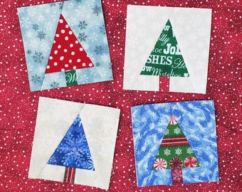 May include: Four different fabric squares with Christmas tree designs. The trees are made from fabric scraps and are in various colors and patterns. The squares are on a red background with white stars.