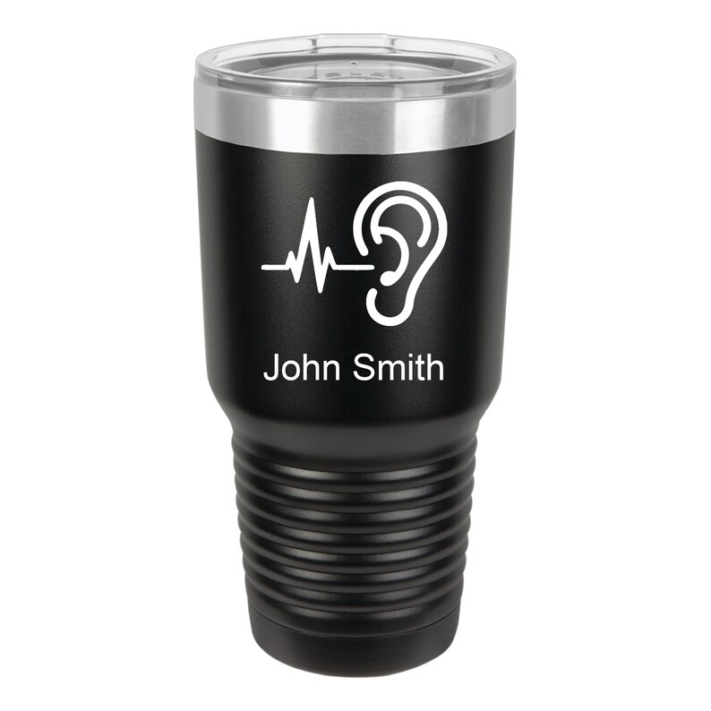 May include: Black stainless steel tumbler with a white ear and heartbeat graphic and the name "John Smith" printed on the side.