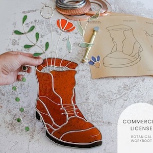 May include: A stained glass workboot with a floral arrangement inside. The boot is brown with black accents and the flowers are red, green, and blue. The image includes the text "COMMERCIAL LICENSE BOTANICAL WORKBOOT".