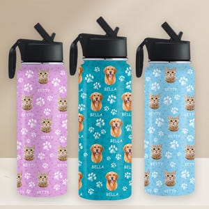 May include: Three stainless steel water bottles with flip-top lids and carrying handles. The bottles are decorated with a paw print pattern and feature images of cats and dogs. The bottles are labeled "Ketty" and "Bella".