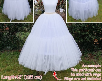 May include: A white tulle petticoat with multiple layers, shown on a dress form. The petticoat is 42 inches (105 cm) long. The text "An example This petticoat can be used with rings Rings are not included" is visible in the image.