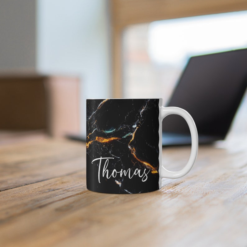 May include: White ceramic mug with a black marble design and the name "Thomas" printed in white on the front.