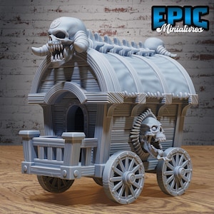 May include: A gray miniature wagon with skull and bone detailing. The wagon features a skull on the front and top, with a detailed wooden design. The wheels are also gray and have a spoke design. The text "EPIC Miniatures" is visible.