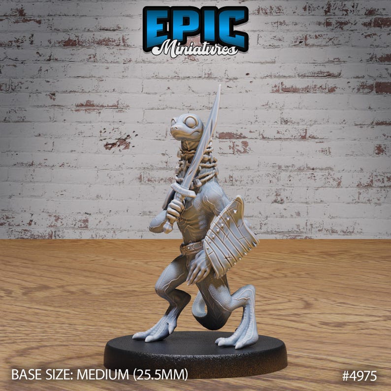May include: A gray, unpainted miniature figurine of a lizard-like creature holding a sword and shield. The miniature is standing on a black base. The base size is medium (25.5 mm).