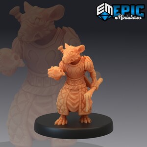 May include: A miniature figurine of a rat wearing armor and holding a weapon. The rat is painted in a light brown color and has a detailed sculpt. The figurine is standing on a black base.