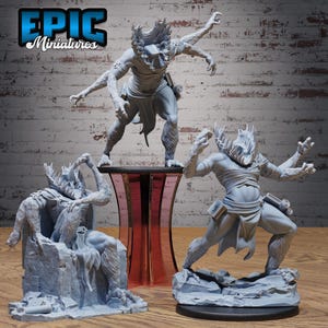 May include: Three grey resin miniature figures of multi-armed creatures with spiky headgear and wrapped torsos. One figure sits on a stone throne, while two others stand in dynamic poses. The text EPIC Miniatures is visible in the top left corner.