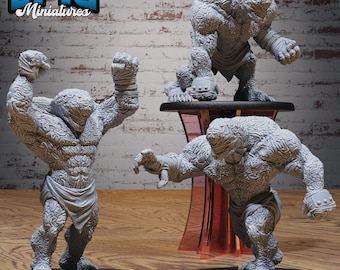 May include: Three gray miniature figures of muscular, humanoid creatures with textured skin and wrapped hands. One figure is posed with arms raised, another is reaching out, and the third is standing on a small table. The logo "EPIC Miniatures" is in the top left corner.