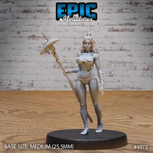 May include: A gray, unpainted miniature figurine of a woman holding a spear. She is wearing a bikini top and a skirt. The base is black and has the text "BASE SIZE: MEDIUM (25.5MM)" and "#4972".