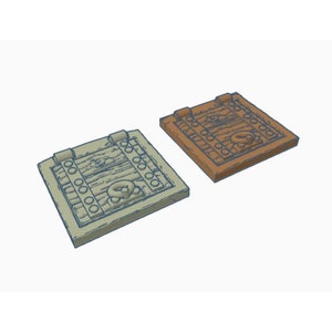 May include: Two wooden treasure chest lids with a skull and crossbones design. One lid is light brown and the other is a darker brown.