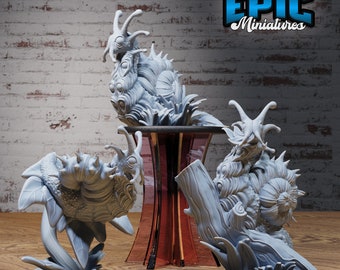 May include: Three gray, detailed, 3D printed miniature sculptures of fantastical creatures. Each creature is perched on a base with a leafy design. The sculptures are arranged on a wooden surface with a red pedestal in the center.