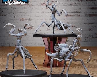 May include: Three gray miniature praying mantis figures. One mantis is standing on a table, another on a black base, and the third on a black base with a backpack. The text "EPIC Miniatures" is in the upper left corner.