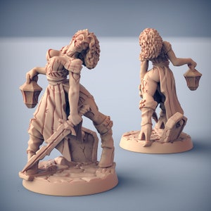 May include: Two painted figurines of women in fantasy-style clothing. One woman holds a sword and a lantern, while the other holds a lantern and is looking over her shoulder.