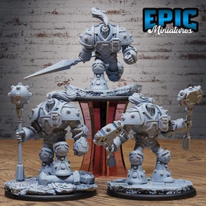 May include: A collection of gray miniature figurines of armored warriors, some holding weapons like a sword and mace. The figurines are on a wooden surface with a red and clear stand in the background. The text "EPIC Miniatures" is in the upper right corner.
