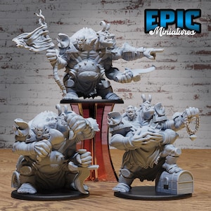 May include: Three gray miniature fantasy figures. The largest figure has three heads and is holding a weapon. The other two figures are in a similar style, one holding a sword and the other holding a string of beads. The Epic Miniatures logo is in the top right corner.