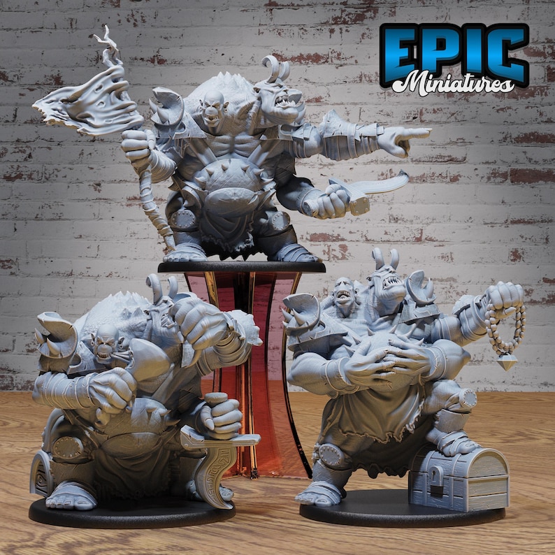 May include: Three gray miniature fantasy figures. The largest figure has three heads and is holding a weapon. The other two figures are in a similar style, one holding a sword and the other holding a string of beads. The Epic Miniatures logo is in the top right corner.