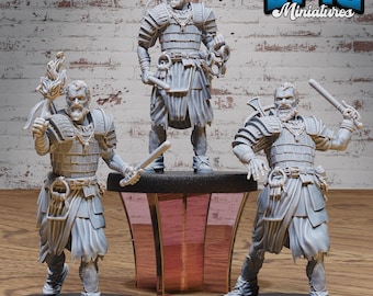 May include: Three unpainted gray plastic miniature figures of warriors wearing armor and holding weapons. The figures are standing on black bases and are arranged in a row on a pink and black platform. The figures are from the Epic Miniatures brand.