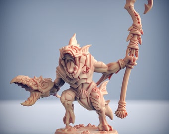 May include: A detailed miniature figurine of a fish-like creature with a toothy grin, holding a staff with a curved hook. The figurine is painted in a light brown color and is posed in a dynamic stance.
