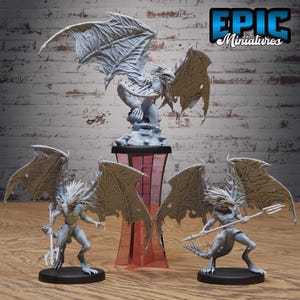 May include: A collection of fantasy miniatures, including winged creatures and a dragon-like figure. The figures are in shades of gray and beige, with intricate details. The logo "EPIC Miniatures" is visible in the top right corner.