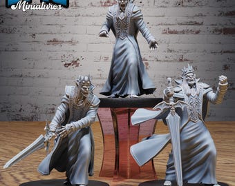 May include: Three gray miniature figures of a skeletal king with crowns and long robes. Two figures hold swords, and one stands on a small table. The figures are on black bases. The text "EPIC Miniatures" is in the upper left corner.