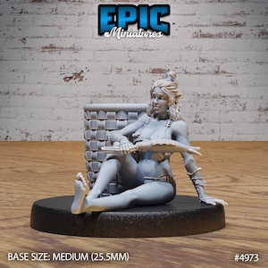 May include: A gray resin miniature of a female figure sitting on a woven basket. She is holding a fish in her right hand and a knife in her left hand. The miniature is on a black round base. BASE SIZE: MEDIUM (25.5MM) #4973