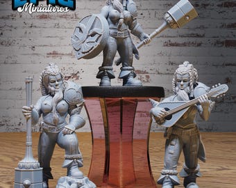 May include: Three gray painted miniature figurines of female dwarves. One dwarf is holding a large hammer, another is holding a shield, and the third is playing a lute.