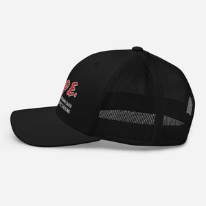 May include: Black trucker hat with a red "HOPE" graphic and the text "DREAM OVER EXPECTATIONS" in white.