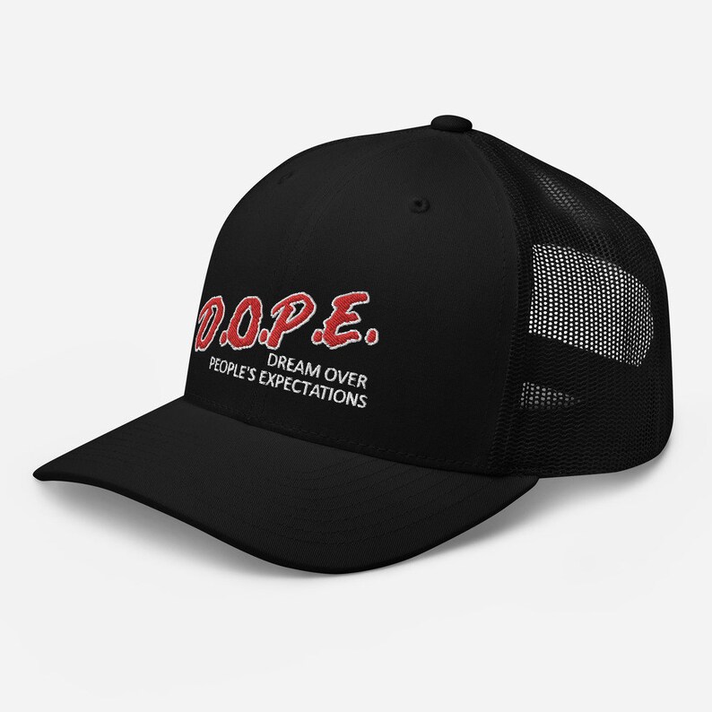 May include: Black trucker hat with a red embroidered logo that says "D.O.P.E. DREAM OVER PEOPLE'S EXPECTATIONS".