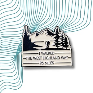 Puede incluir: Pin de esmalte blanco y negro que representa a un excursionista en un sendero de montaña con el texto "I walked the West Highland Way - 96 miles".