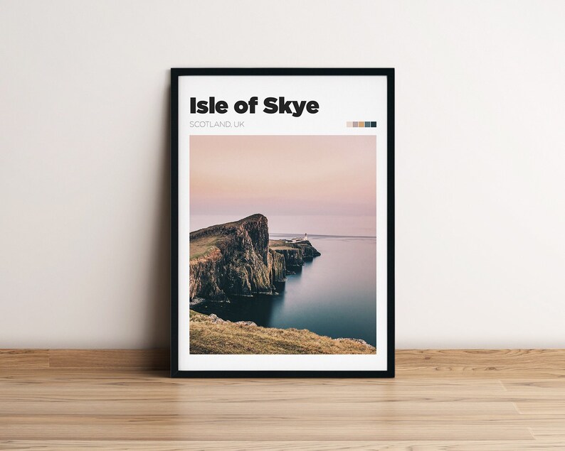 May include: A black framed print with the text "Isle of Skye, SCOTLAND, UK" and a photograph of a rocky cliff overlooking a body of water. The sky is a soft pink and purple.