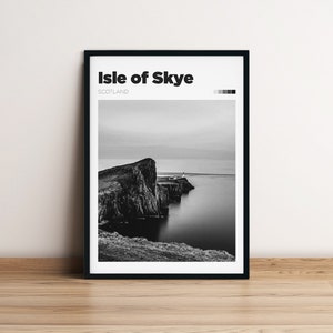 May include: Black and white photograph of a rocky cliff on the Isle of Skye, Scotland. The cliff is surrounded by water and there is a small building on top of the cliff.