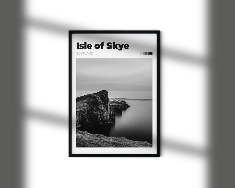 May include: A black and white photograph of a rocky cliff on the Isle of Skye, Scotland. The cliff is surrounded by water and the sky is cloudy.