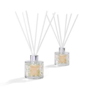 May include: Two clear glass reed diffusers with silver lids and white reeds. The bottles feature a floral design and the text "Harriet Green" and "Vanilla Garden". They are set against a white backdrop.