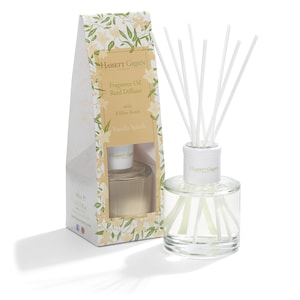 May include: A clear glass bottle with a white lid and white reeds, filled with a vanilla scented reed diffuser. The bottle is labelled "Hassett Green" and "Vanilla Splash".