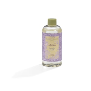 May include: A clear glass bottle with a green lid filled with a light yellow liquid. The bottle has a label with the text "Hassett Green London" and "Fragrance Oil Diffuser Refill Lavender Vanilla 250ml e 8.45 US fl.oz."